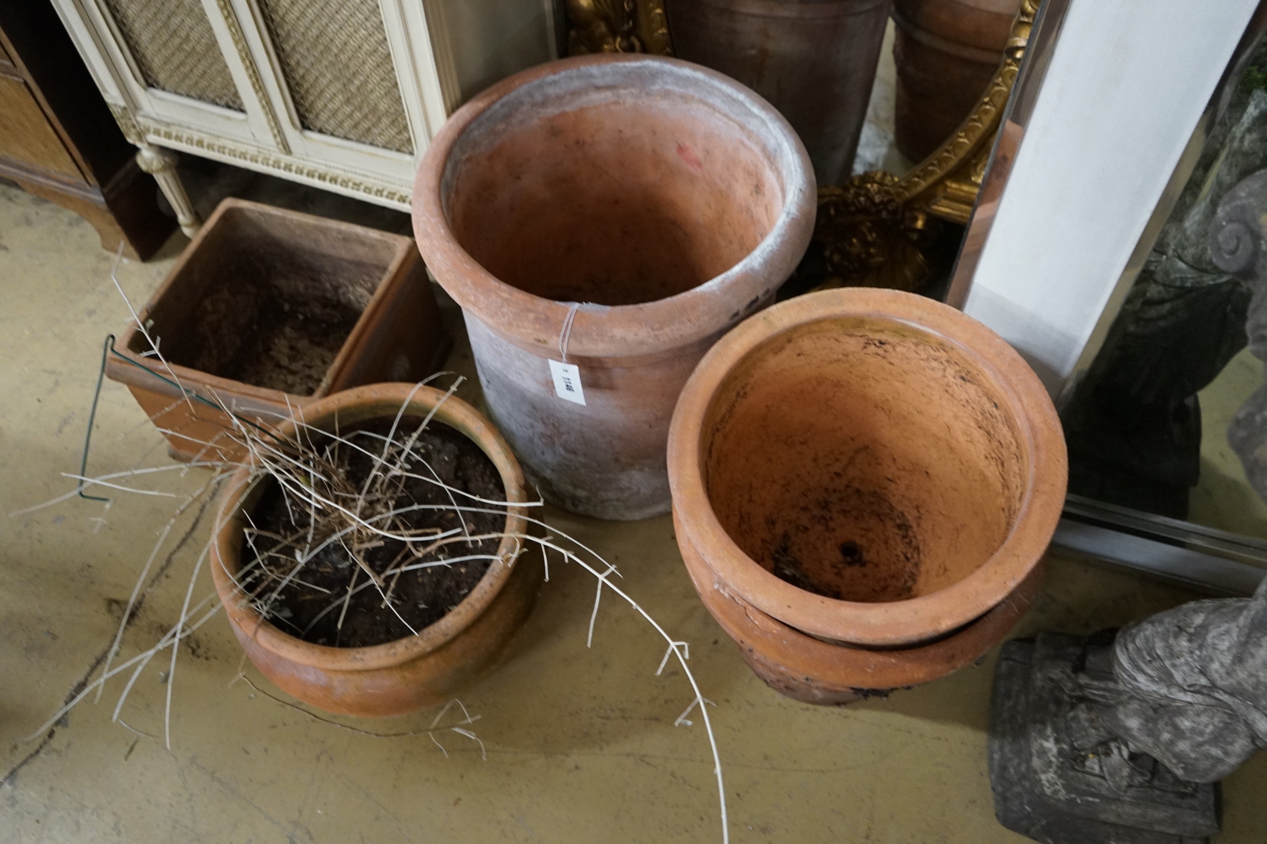 Four circular terracotta garden planters, together with a square planter, largest diameter 48cm, height 48cm